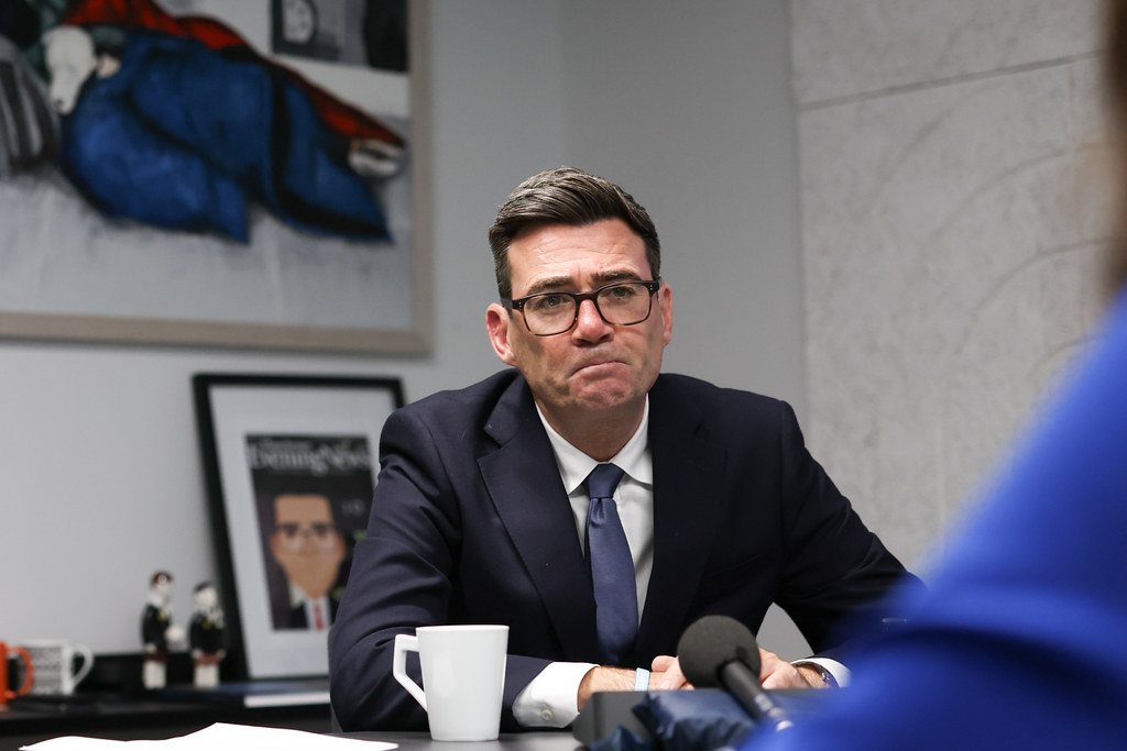 Andy Burnham speaking at a press conference in his office.